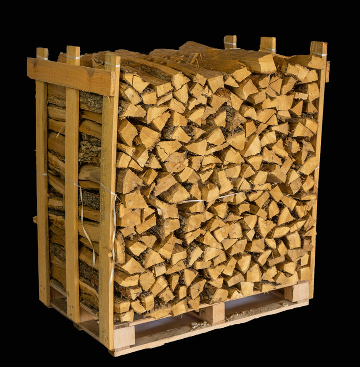 Stack of large post oak cooking wood logs on a clean surface, ready for barbecuing and smoking.