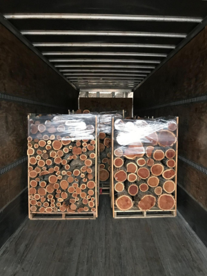 cut wood pieces stacked and secured on the back of a truck