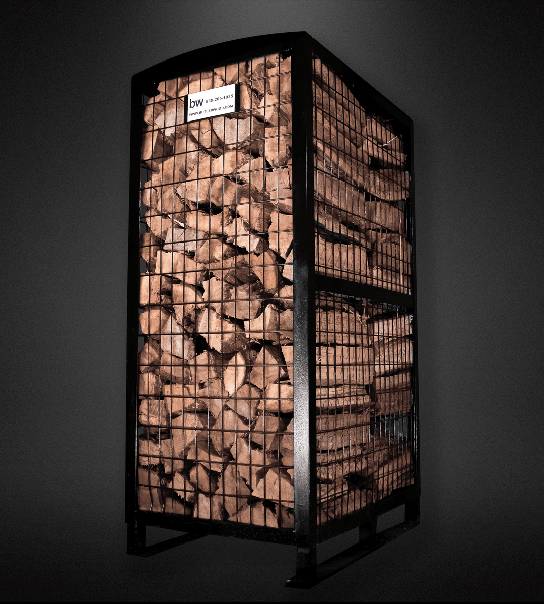 Pecan firewood storage unit with metal mesh design on a dark background