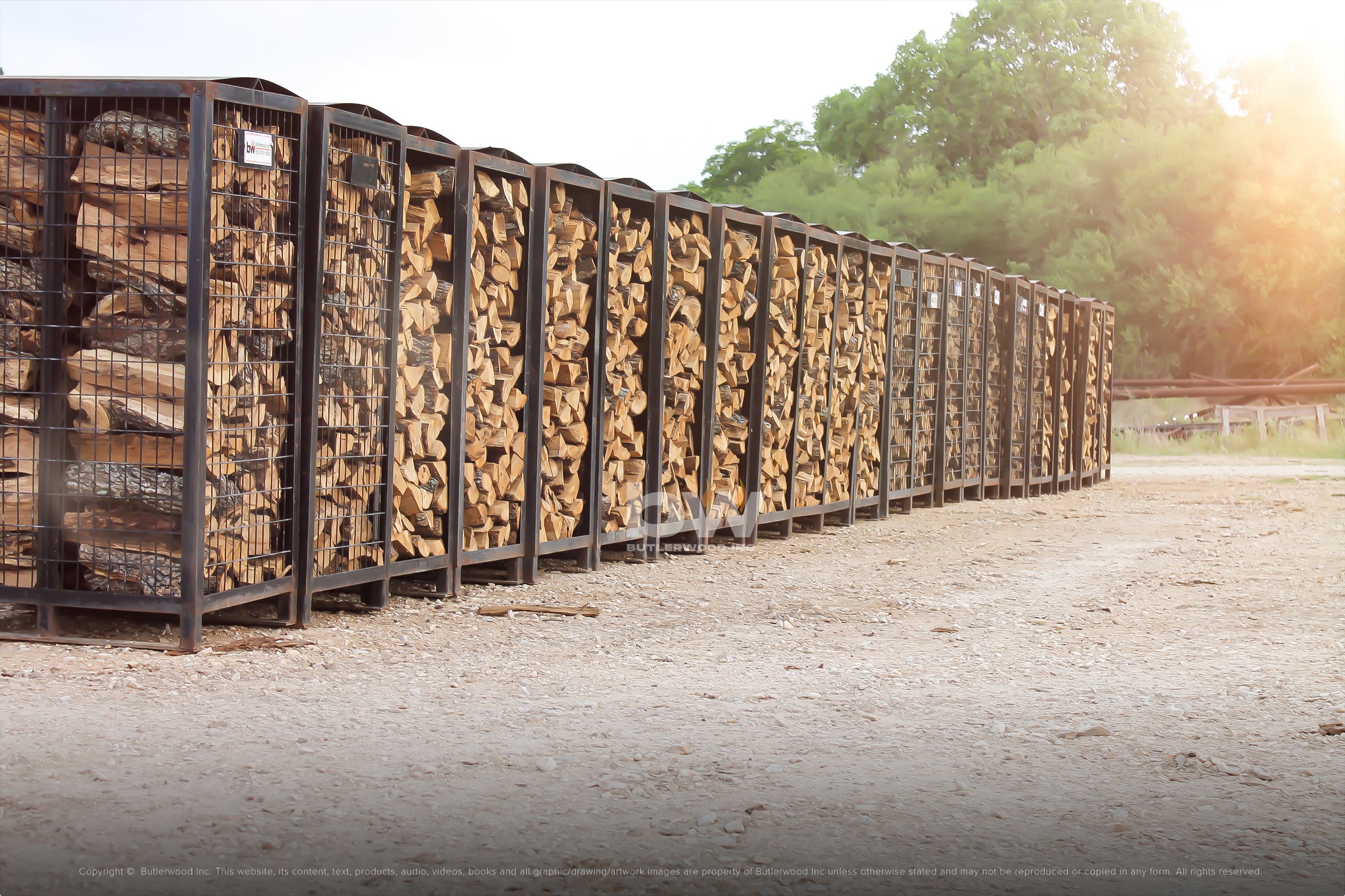 Firewood stacked in tall piles in metal storage racks.