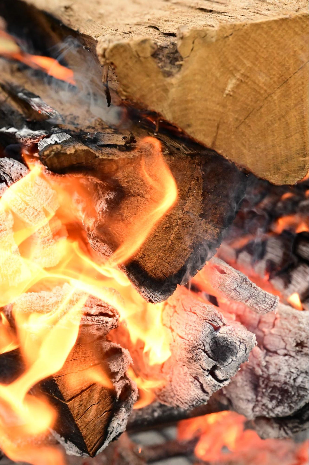 Close-up of burning wood with flames and embers